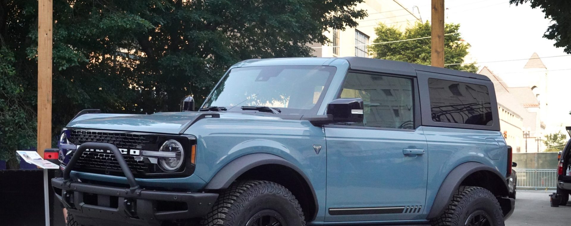 A blue Ford Bronco parked in front of a large wooden Bronco sign. How much weight can a Ford Bronco tow?
