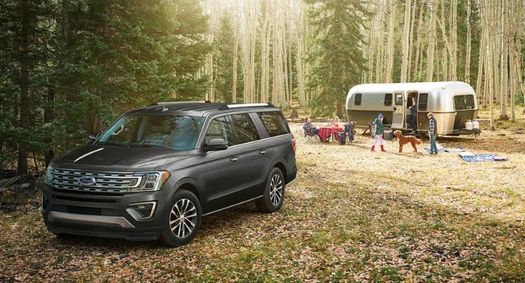 A black Ford Expedition Timberline is parked near a trailer.