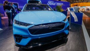 A blue 2021 Ford Mustang Mach-E is on display.