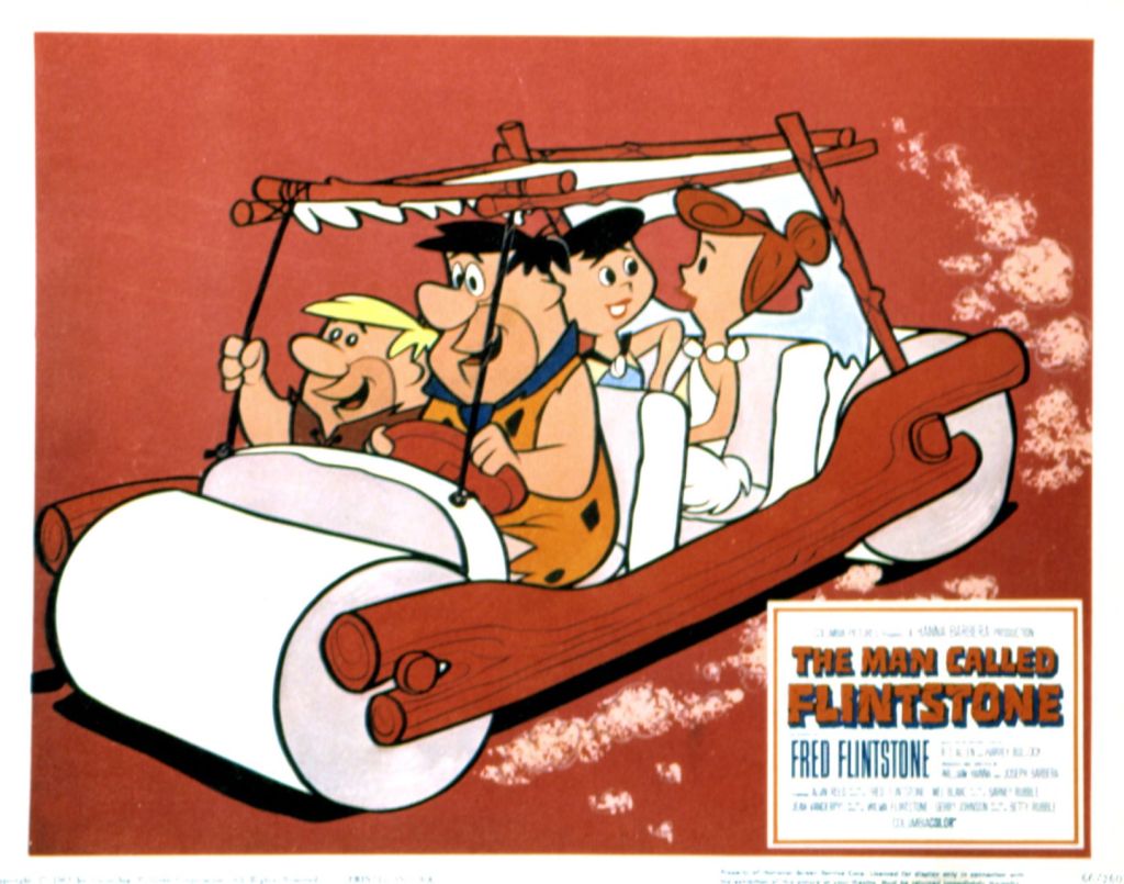 Fred Flintstone driving the Flintstone Mobile from The Flintstones