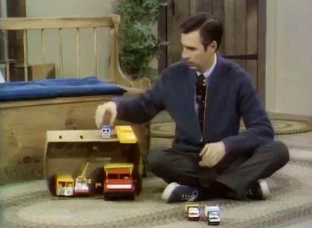Fred Rogers playing with toy cars on Mister Rogers' Neighborhood