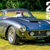 A silver GTO Engineering Ferrari 250 GT SWB Revival parked on a lawn