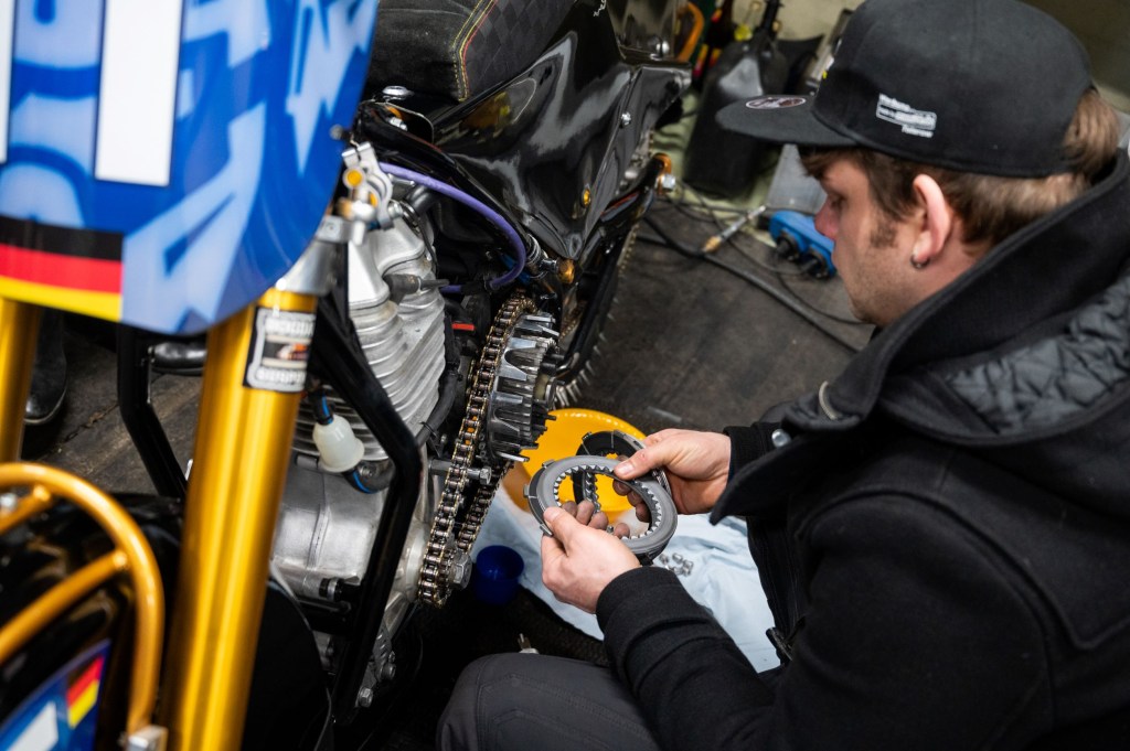 German Speedway racer Max Niedermaier examines his racing motorcycle clutch plates