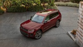 red Jeep Grand Cherokee L in a driveway