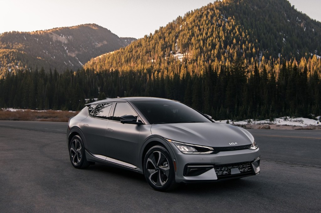 Gray 2022 Kia EV6 electric crossover SUV with mountains in the background, it has a better electric driving range than the Hyundai Ioniq 5.