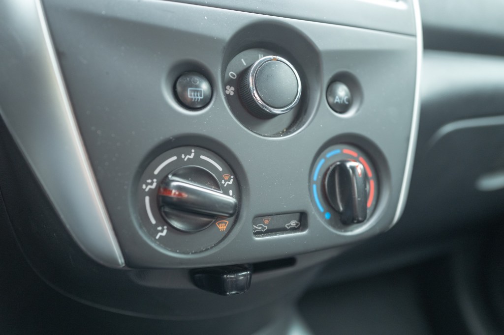 Knobs of automobile climate control system on the center console of Nissan automobile. 