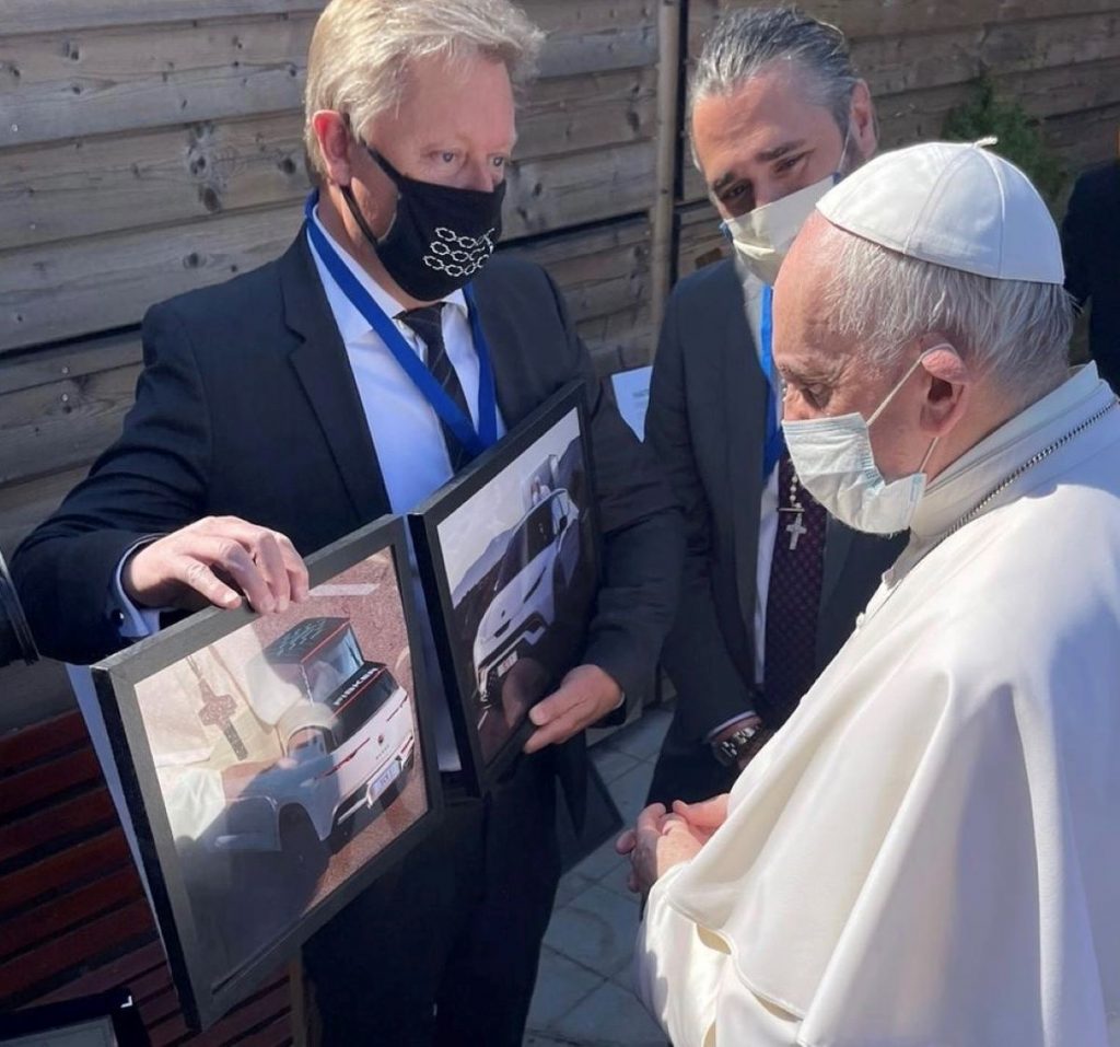 Henrik Fisker showing images of a Fisker Ocean Popemobile to Pope Francis