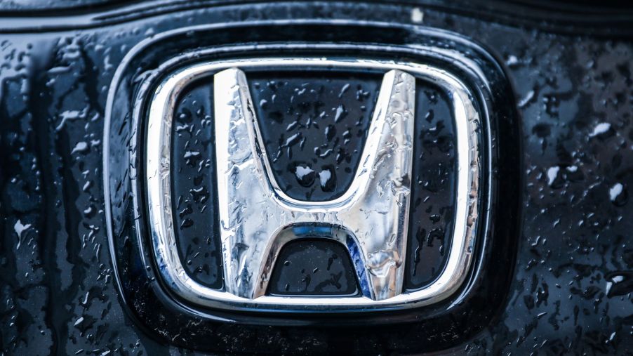 A chrome Honda logo on a black background.