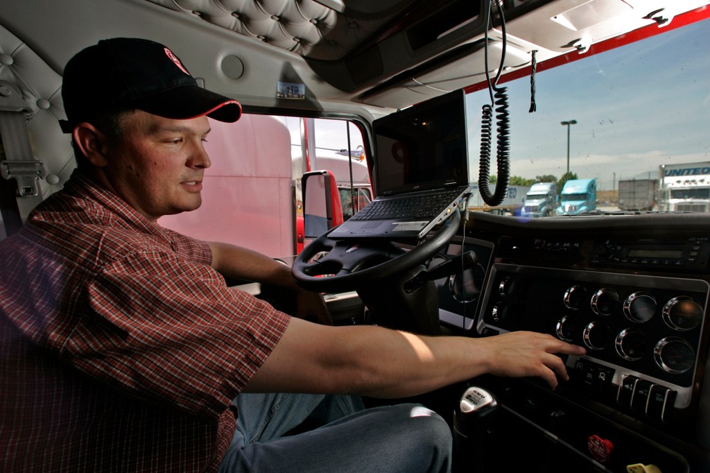 Driver sitting inside semi-truck