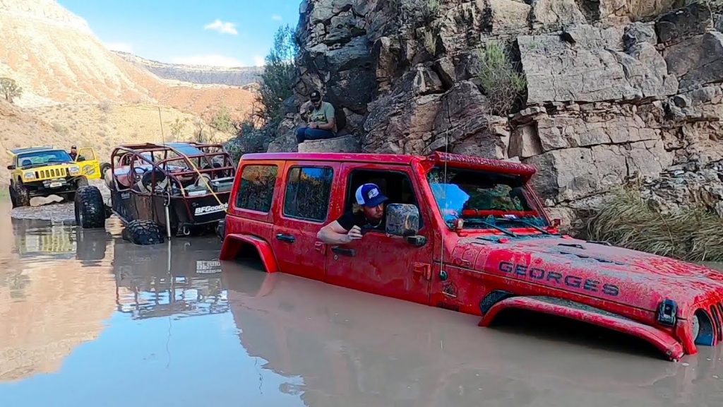 Red Jeep Wrangler stuck in a River with Matt's Off-Road Recovery to the rescue