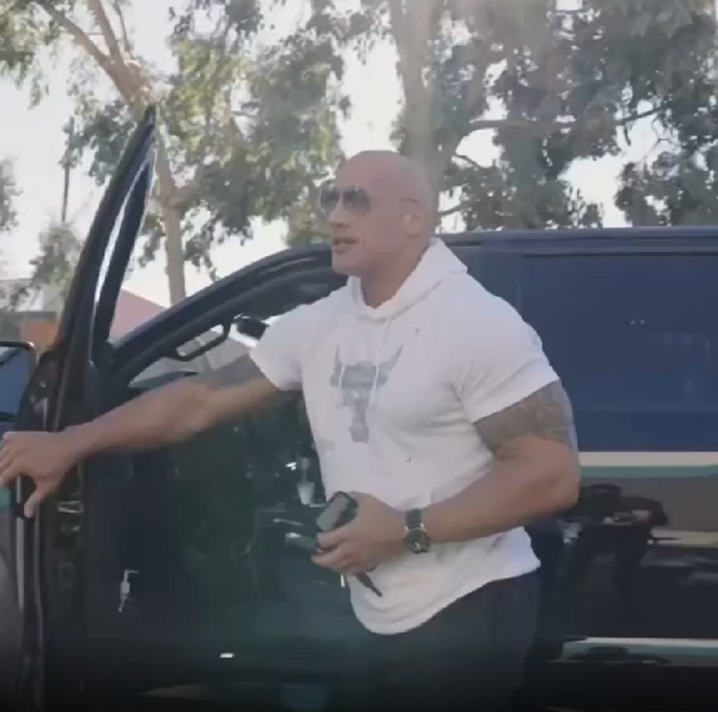 Dwayne Johnson getting out of his Ford F-150. Johnson gave his truck to a veteran at a movie premiere.