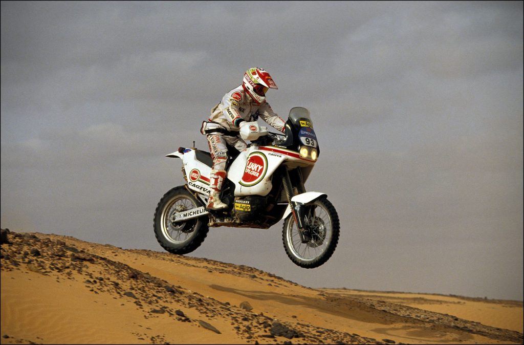 Jorge Arcarons on a white-black-red-and-gold Lucky Strike Cagiva Elefant at the Paris-Dakar Rally