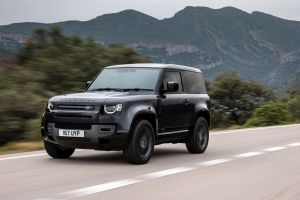 The Land Rover Defender 90 V8 luxury off-road SUV driving down a highway