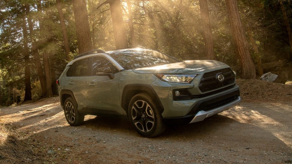 Lunar Rock 2021 Toyota RAV4 driving through a forest, it's one of the best commuter SUVs, according to KBB.