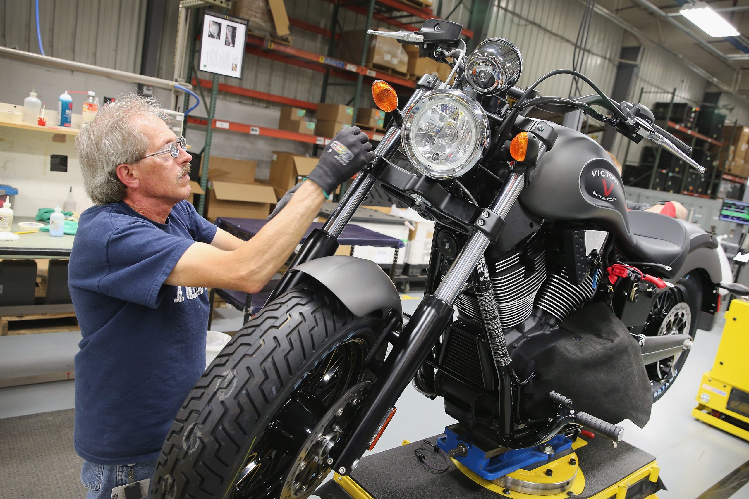 Man working on Victory motorcycle