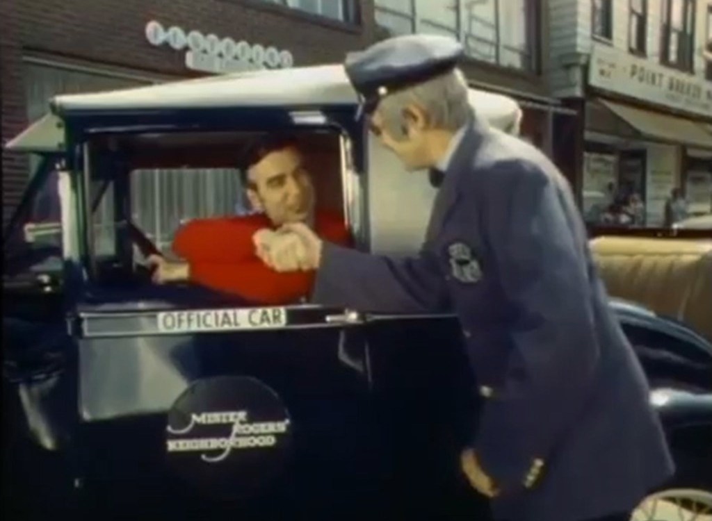 Mister Rogers in his classic 1928 Ford Model A Sport Coupe, shaking hands with Mr. McFeely