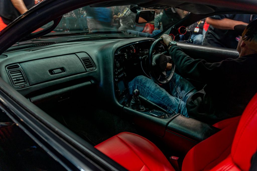 The red-leather front seats and black carbon-fiber-trimmed dashboard of the modified 1994 Toyota Supra Mk4 Turbo at the 2021 Mecum Chicago auction