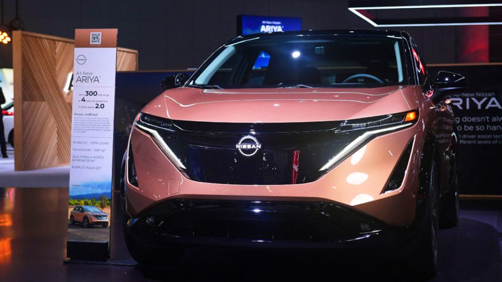 A copper-color 2023 Nissan Ariya is on display.