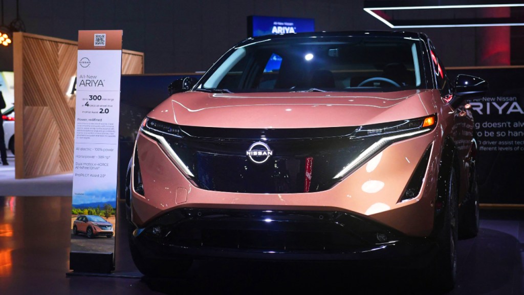 A peach-color 2023 Nissan Ariya is on display.