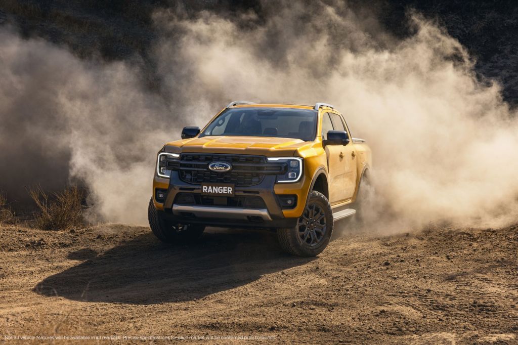 Orange 2023 Ford Ranger driving off-road on a dirt road
