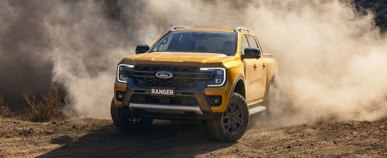Orange 2023 Ford Ranger driving off-road on a dirt road