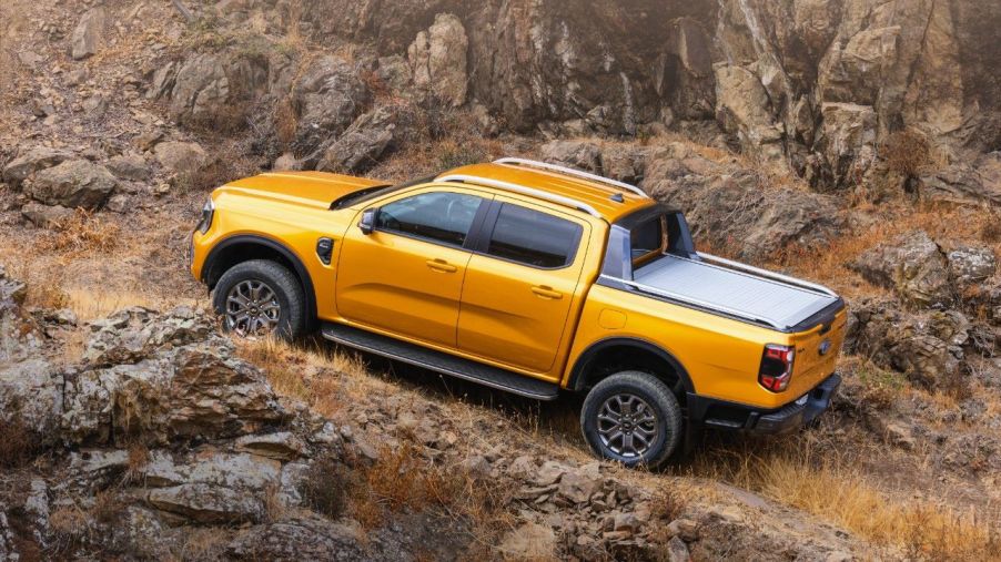 Orange 2023 Ford Ranger driving off-road on rocky terrain: A Ranger Raptor to follow?