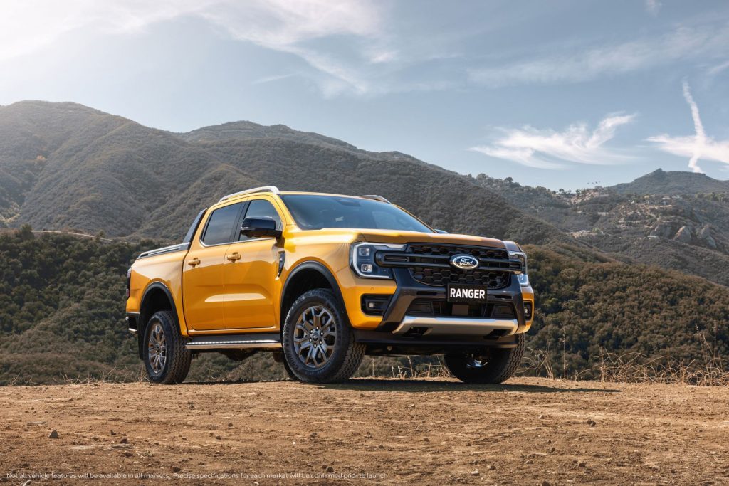 Orange 2023 Ford Ranger with mountains in the background
