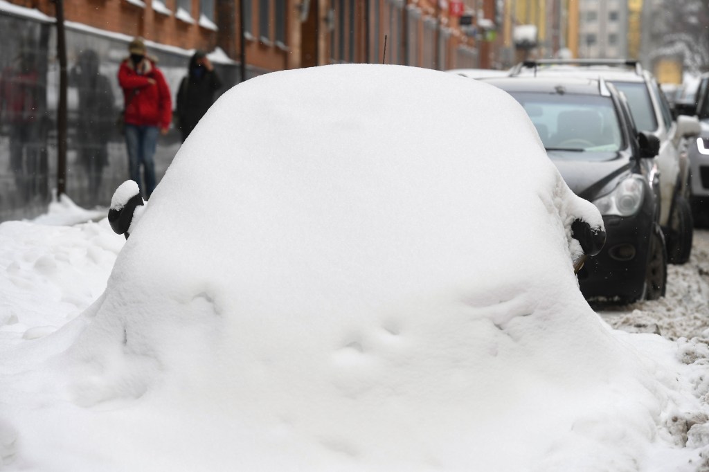 Parked car covered in snow