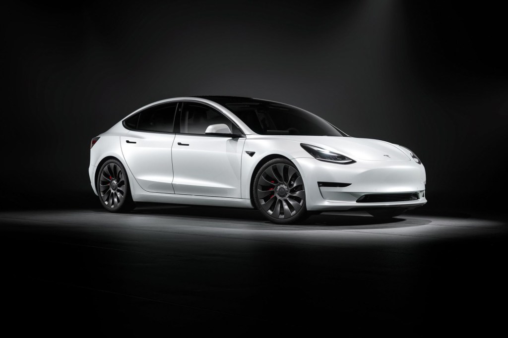 Passenger's side front angle view of white 2022 Tesla Model 3, which has a long driving range