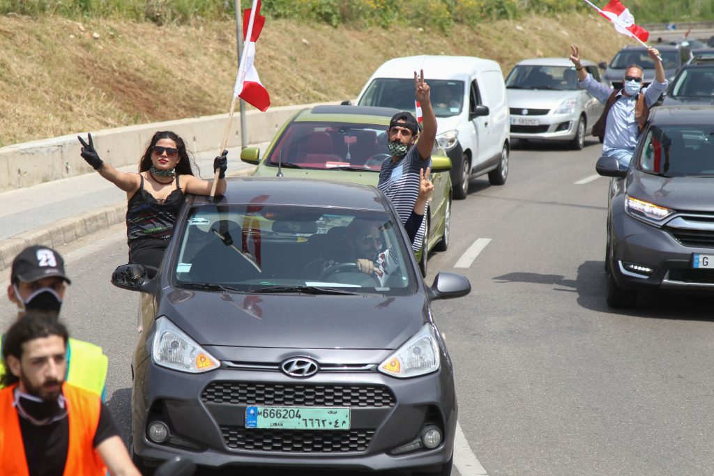 People stick their heads out of car windows