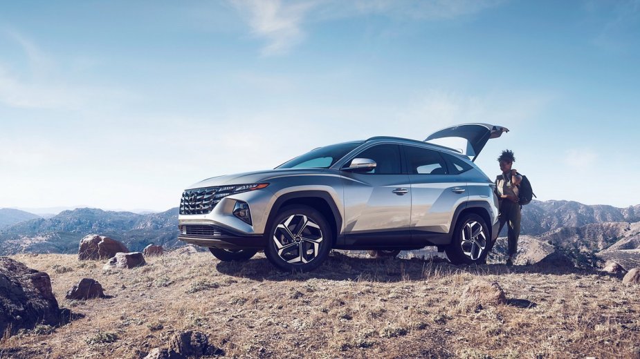 Sparkling silver 2022 Hyundai Tucson parked on top of a mountain