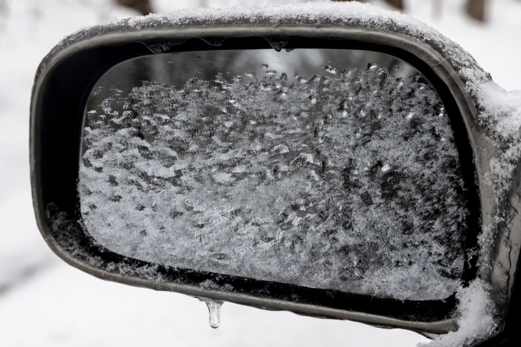 Side view mirror covered in ice