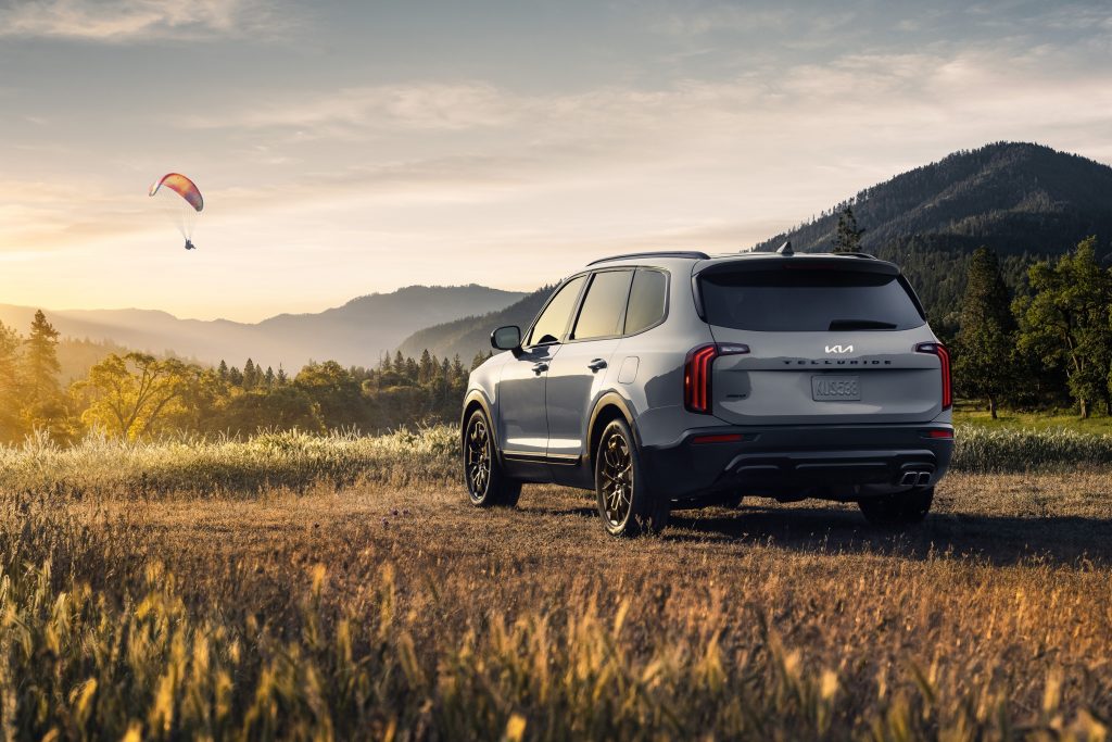 Silver 2022 Kia Telluride, a good SUV for sleep, parked in a field