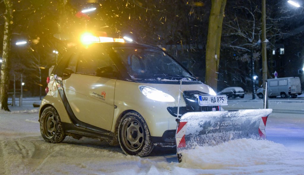 Smart car fitted with snow plow