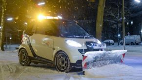 Smart car fitted with snow plow