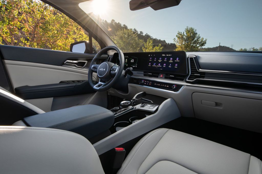 Steering wheel, touchscreen, and front seats in 2023 Kia Sportage Hybrid