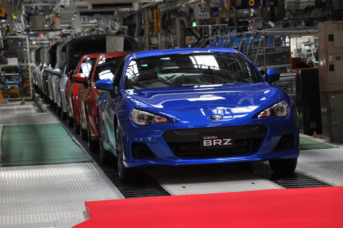 Blue Subaru BRZ coming off a factory assembly line. Subaru recently announced that it expects profits to drop by nearly half due to the global chip shortage