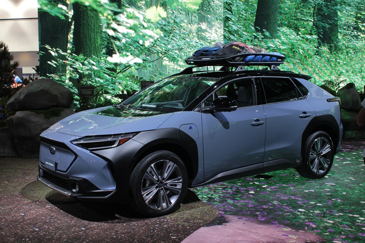 2023 Subaru Solterra with a roof rack and camping accessories tied to it