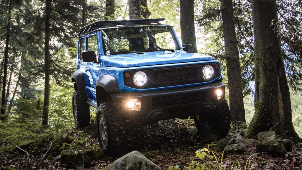Custom Suzuki Jimny stomping through the woods now has more ground clearance than a Jeep Wrangler Rubicon 392
