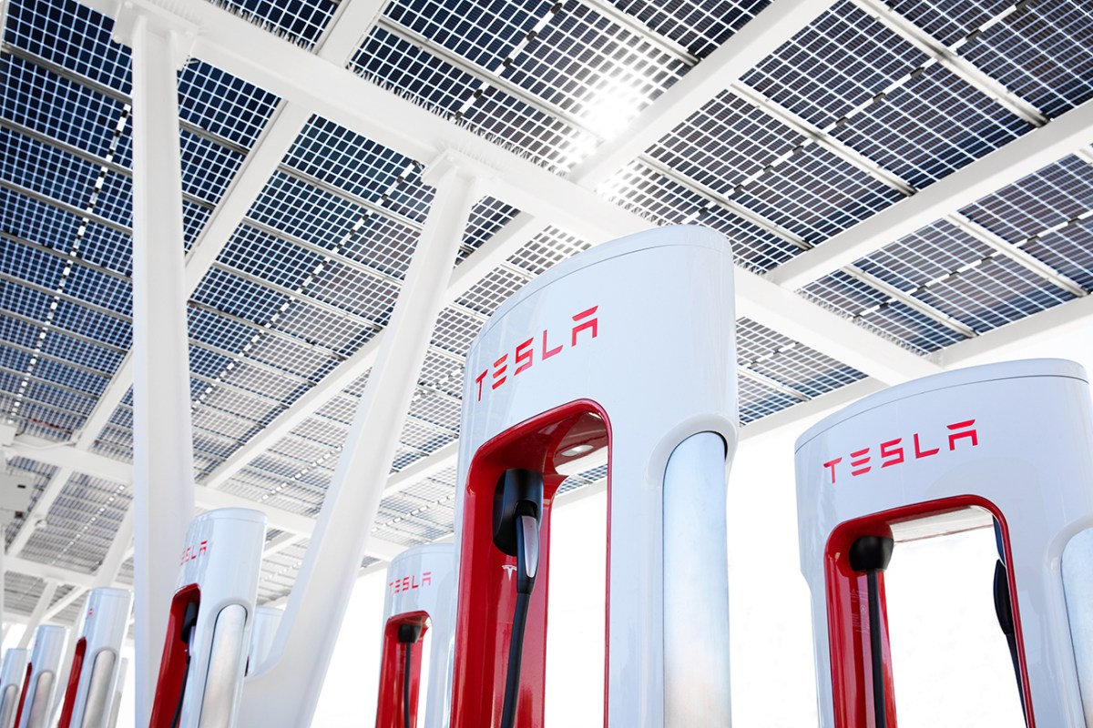 A white and red Tesla supercharger unit