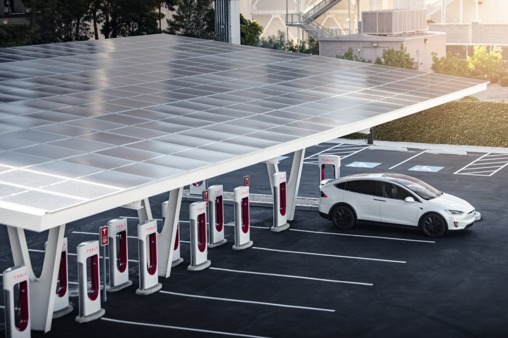Tesla at Supercharger Electric Car Charging Station