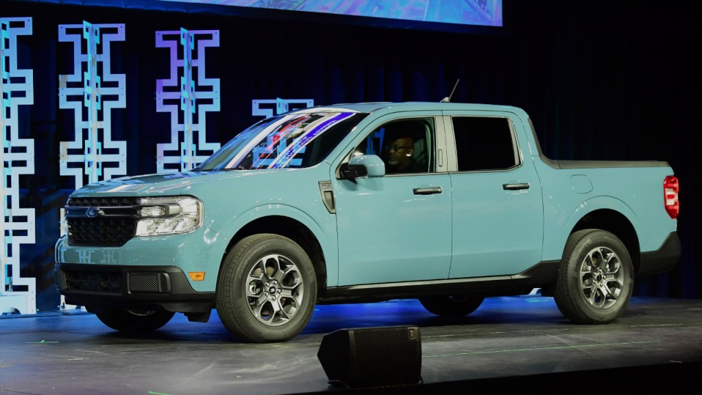 A blue 2022 Ford Maverick small pickup truck is on display.