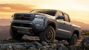 2022 Nissan Frontier parked on rocks in front of the sunset.