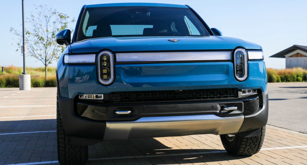 A blue 2022 Rivian R1T is parked.