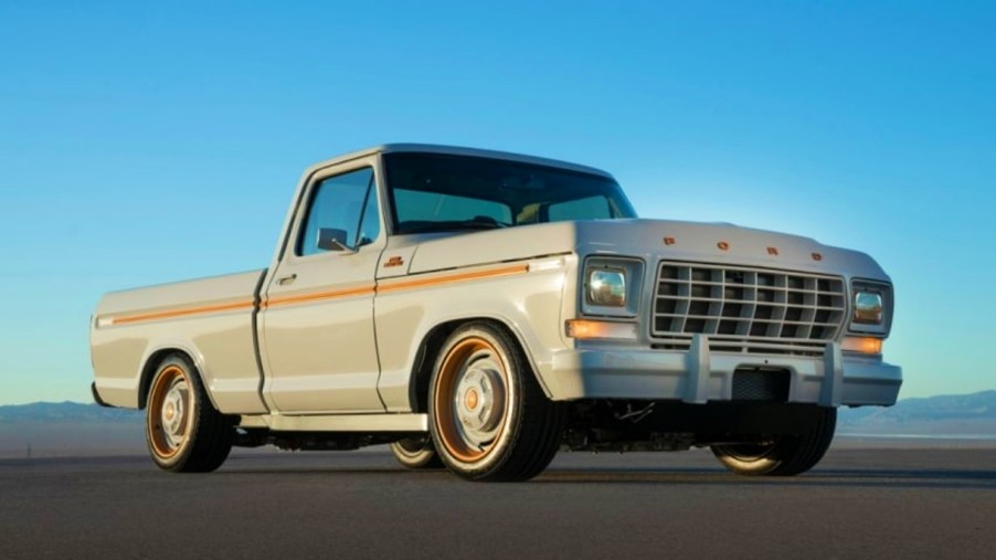 A white Ford F-100 concept truck is on display.