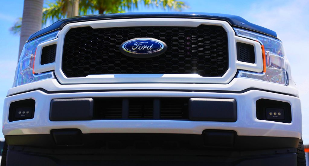 The front of a white Ford F-150 pickup truck. 