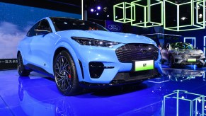 A blue Ford Mustang Mach-E electric SUV is on display.