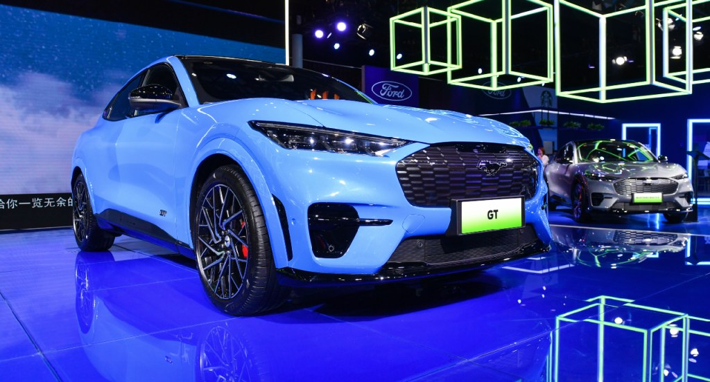 A blue 2021 Ford Mustang Mach-E electric SUV is on display.
