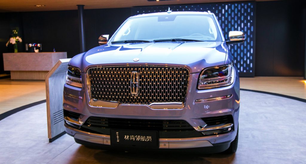 A blue Lincoln Navigator is on display.