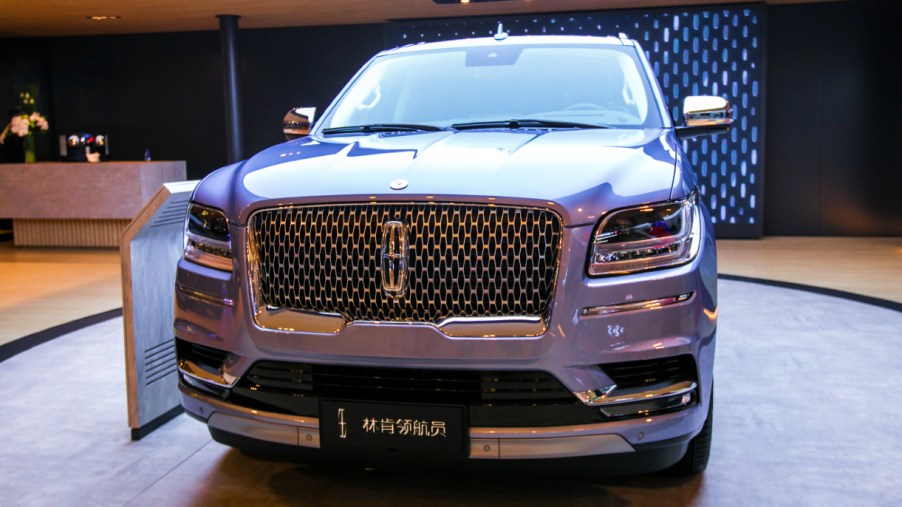 A light blue Lincoln Navigator is on display.